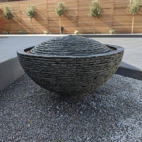 1m Grey Semi-sphere on a small pedestal surrounded by grey pebbles. A great feature in this newly designed garden in The Wirrel